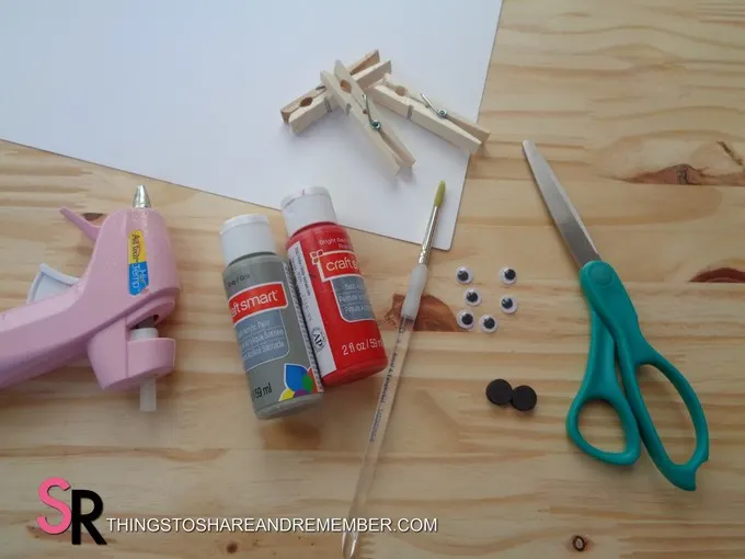 glue gun, paint, brush, clips and scissors for shark clip craft