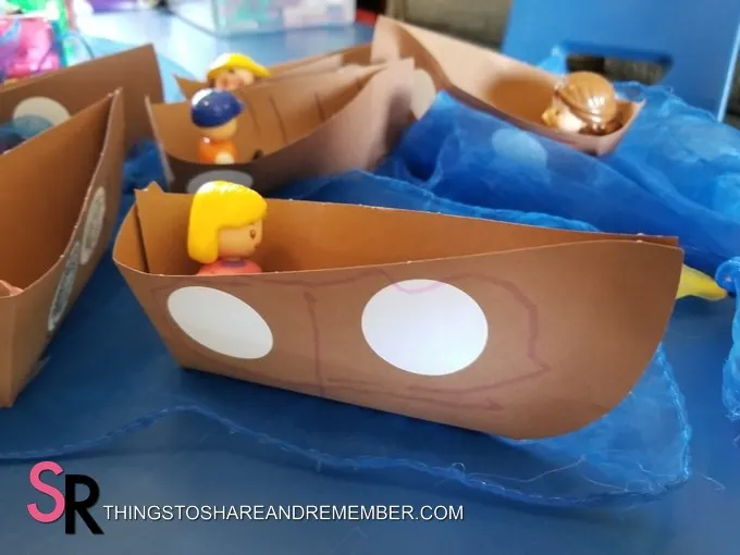 paper boats with dolls