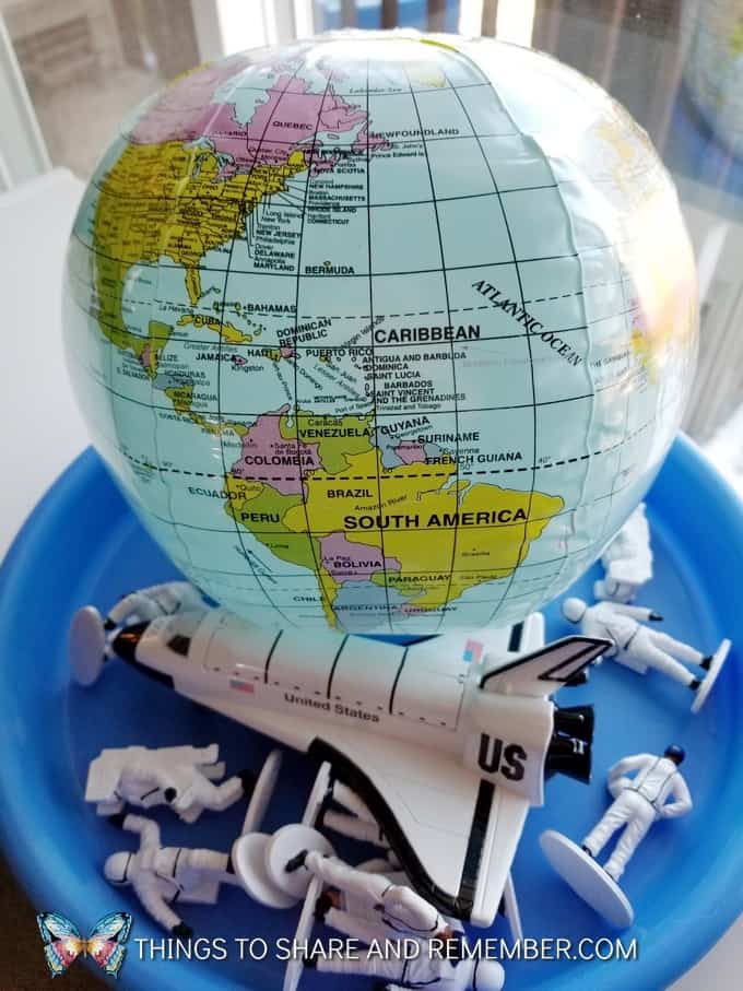 earth globe and space shuttle with astronauts 