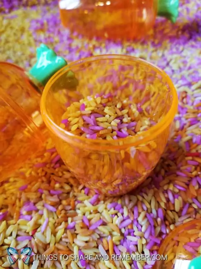 colored rice and fillable carrot easter eggs sensory bin