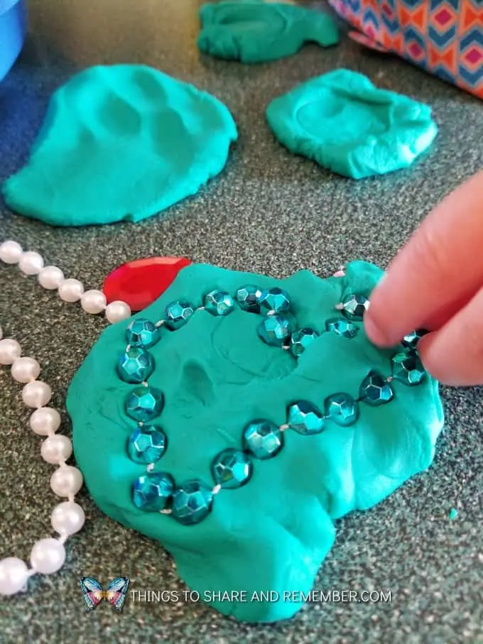 pressing beads into play dough Gems and Jewels Sensory and Sorting Play Activities Preschool Activities