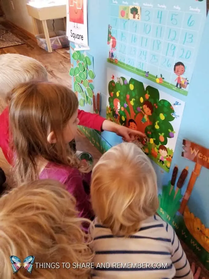 children using mother goose time theme poster during  super fun circle time