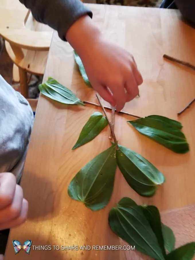 making a design with leaves and sticks Loose Parts Nature Designs