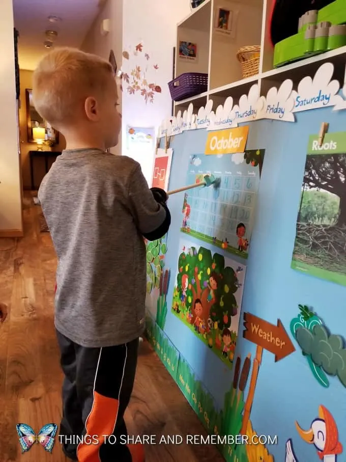 child pointing to the calendar with pointer  super fun circle time