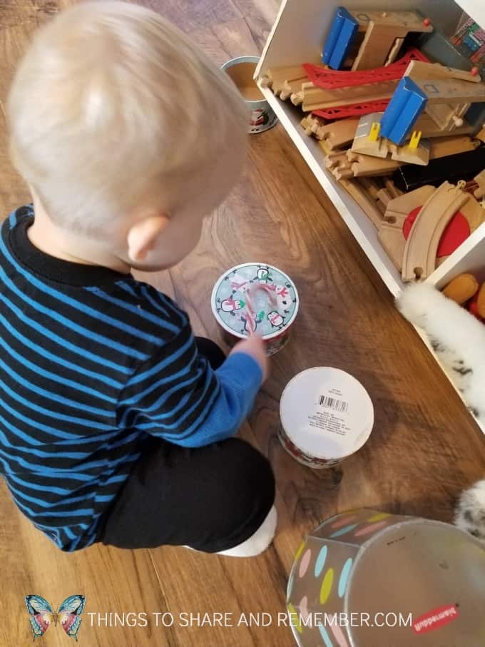 Creating a drum with toys - plastic candy canes and boxes. Making noise with creative "drum" alternatives. #MGTblogger #MotherGooseTime #SightsandSounds 