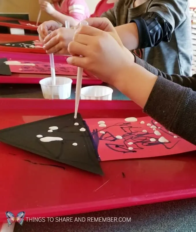 Dripping icicles art activity for winter ice lessons. Painting with thinned paint and pipettes to make icicles. #MGTblogger #MotherGooseTime #SightsandSounds 