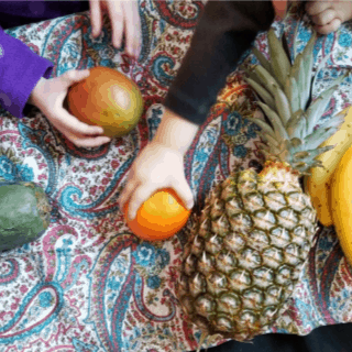 children exploring different kinds of fruit