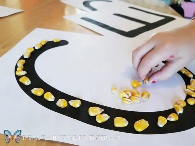 Corn Letters - grains pre-writing activity and fine motor skills with corn kernels Sensory Shape Discovery Search and Match with grains - Mother Goose Time Health and Fitness theme for February 2019 - Preschool curriculum Food Groups - Grains activities #MGTblogger #MGTHealthandFitness #ece #preschool #nutritiontheme
