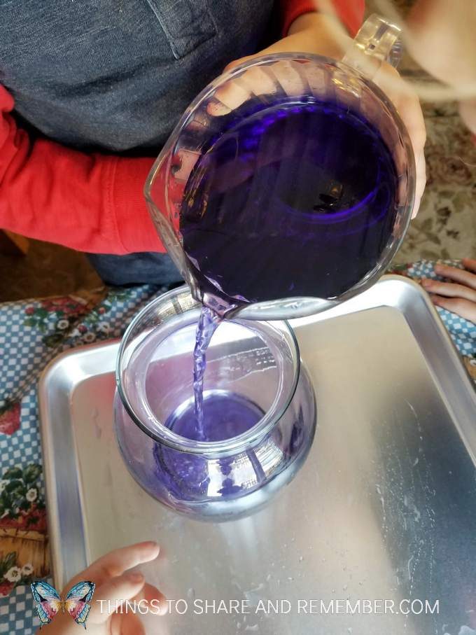 Pouring Together Community Challenge from Mother Goose Time - pouring colored water from pitcher to vase measuring and pouring preschool activities