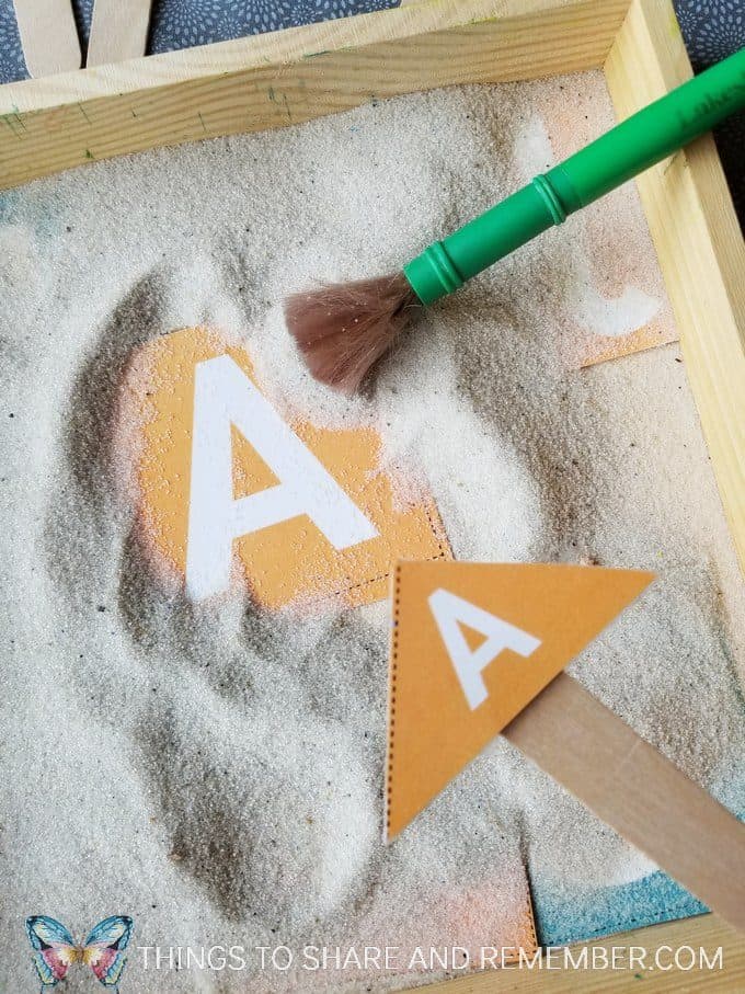 Pouring Sand Tabletop Literacy activity matching letters with Mother Goose Time measuring and pouring preschool activities