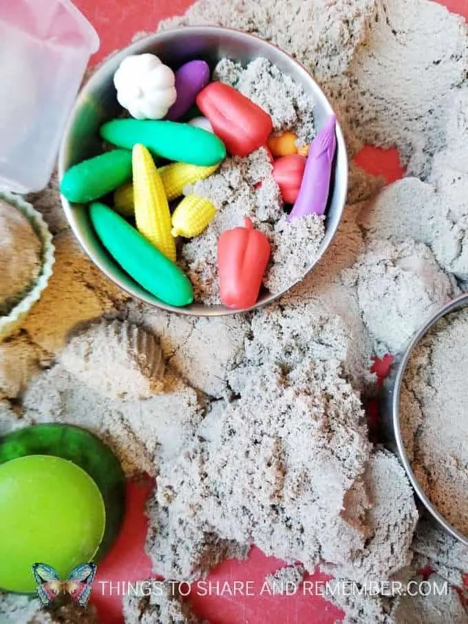 Kinetic sand sensory bin with Learning Resources Mix and Measure set and vegetable counters - for kitchen and baking preschool theme measuring and pouring preschool activities