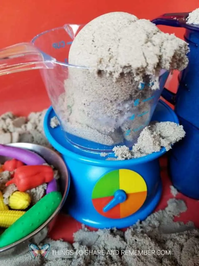 Kinetic sand sensory bin with Learning Resources Mix and Measure set and vegetable counters - for kitchen and baking preschool theme measuring and pouring preschool activities