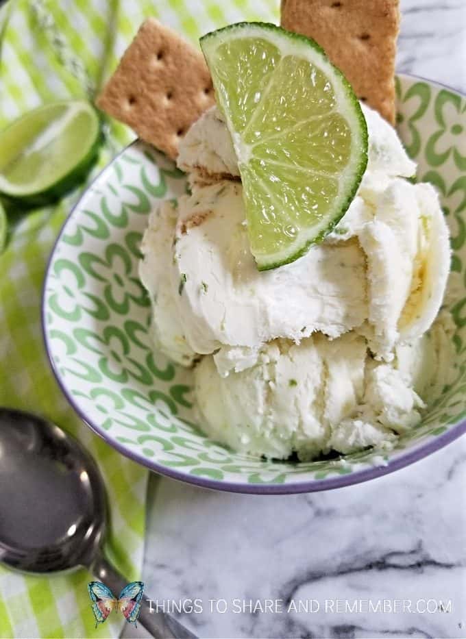 Key lime pie ice cream in a dish with lime slice and graham cracker garnish
