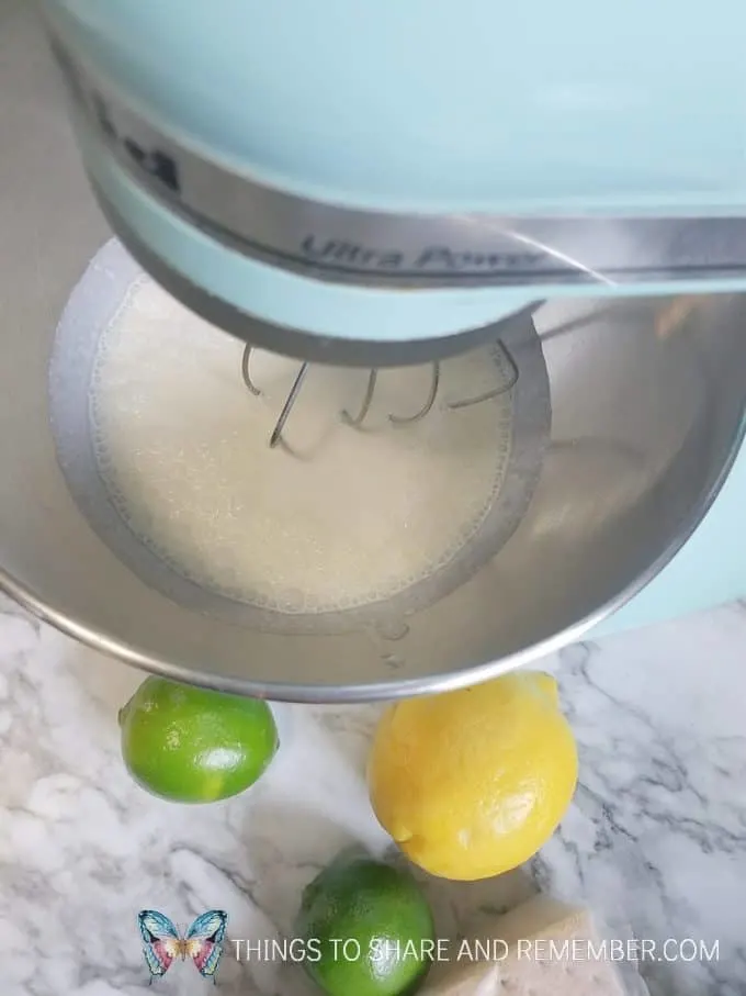 mixing no churn key lime pie ice cream in Kitchenaid mixer with limes and lemon