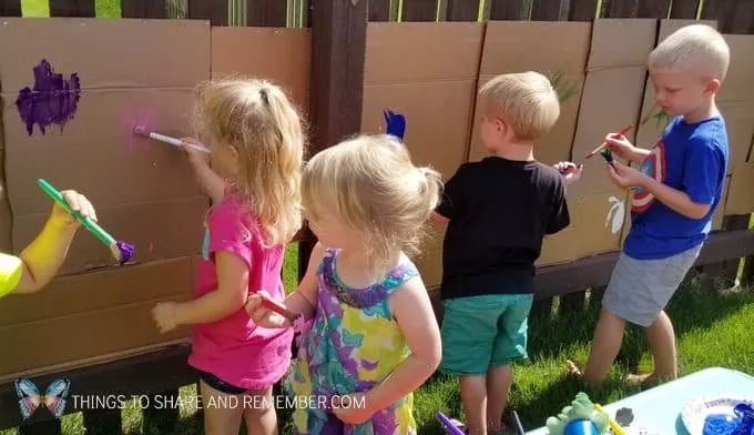 children painting outdoors