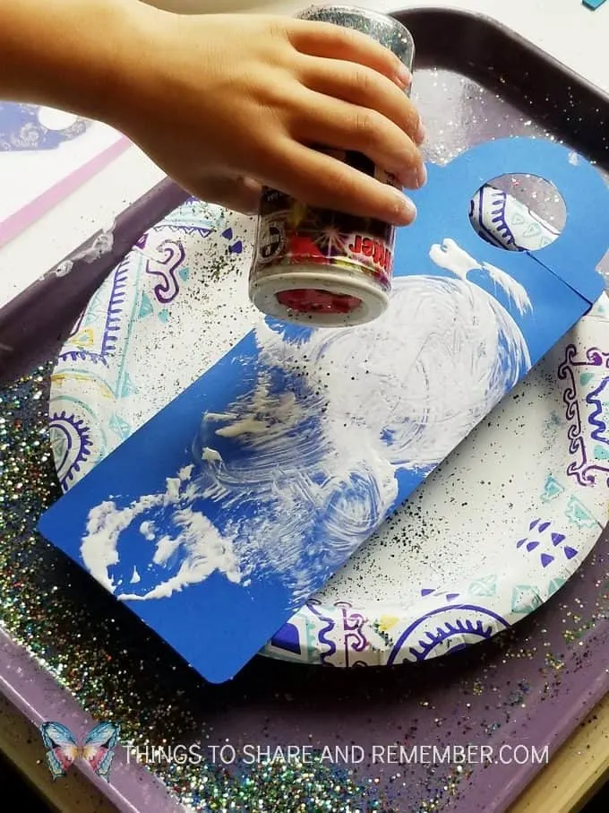 sprinkling glitter Starry Night Door Hanger Make & Play Activity Art Studio - Mother Goose Time Preschool Curriculum