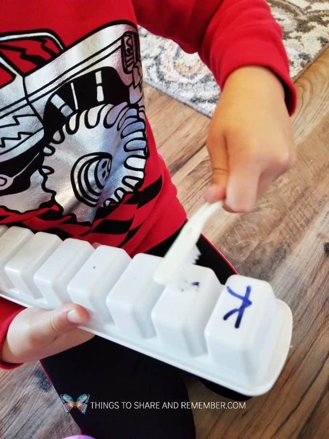 Preschool Dental Health Activities Experience Preschool Brushing Dry Erase Letters off ice cube trays with toothbrushes