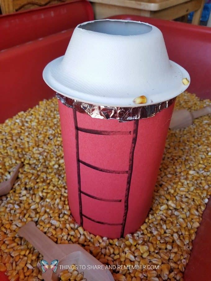 Fill the Silo Farm Sensory Bin Silo made from an oatmeal container | Experience Preschool Curriculum | Down on the Farm preschool theme 