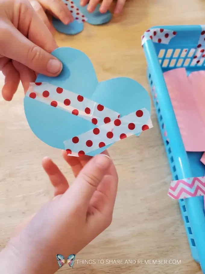 taping together heart shapes Humpty Dumpty Nursery Rhyme Activities