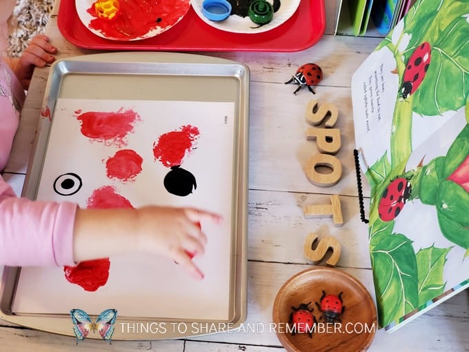 red and white ladybug spots painting with bottle caps