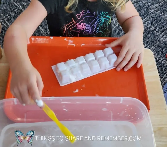 brushing teeth with a toothbrush, ice cube tray and shaving cream