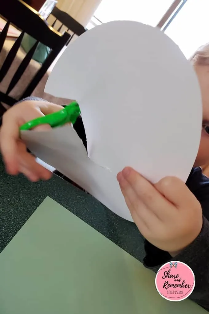 Cutting a crack in a paper egg.