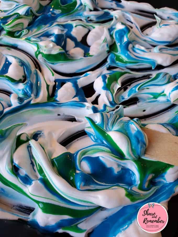 Blue and green marbled paint in shaving cream.